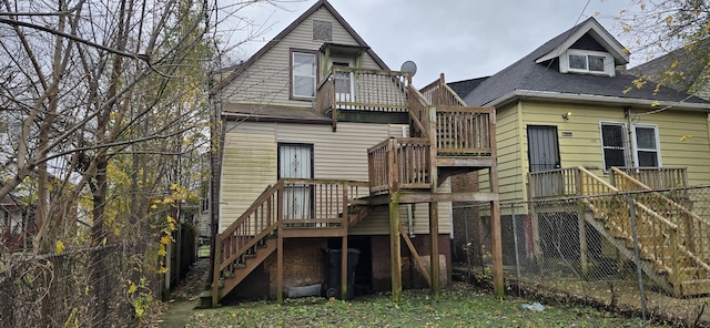 rear view of property with a deck and stairway