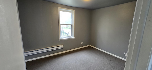 unfurnished room with a baseboard radiator and baseboards