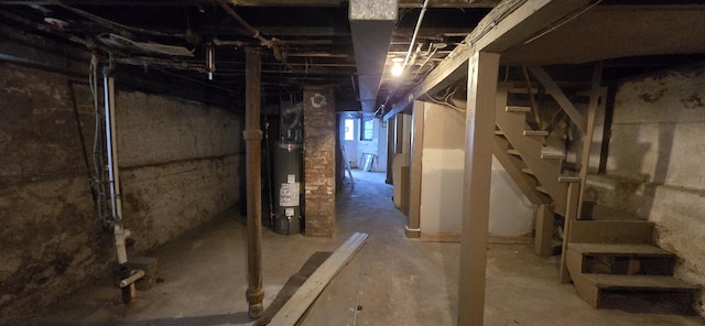 below grade area featuring water heater and stairway