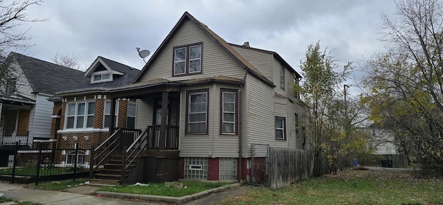 view of front of home featuring fence