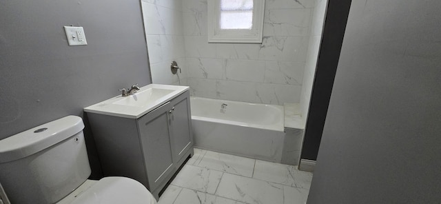 bathroom with toilet, marble finish floor, tub / shower combination, and vanity