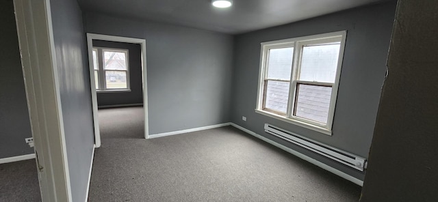 unfurnished room featuring carpet floors, baseboards, and baseboard heating