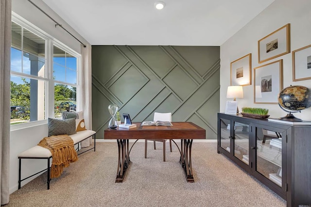 carpeted office featuring a decorative wall