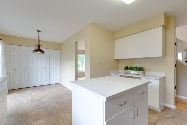 621 Raintree Rd, Buffalo Grove, IL 60089 - kitchen featuring light countertops, light tile patterned floors, hanging light fixtures, white cabinetry, and a center island