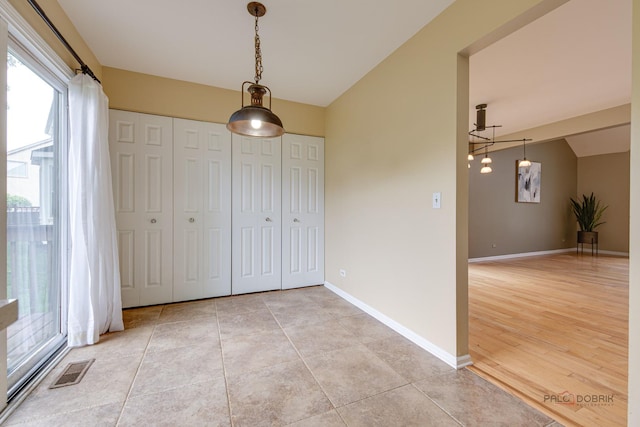 621 Raintree Rd, Buffalo Grove, IL 60089 - unfurnished dining area with baseboards and light tile patterned flooring