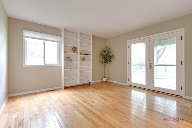 621 Raintree Rd, Buffalo Grove, IL 60089 - spare room featuring healthy amount of natural light, light wood-style floors, and french doors