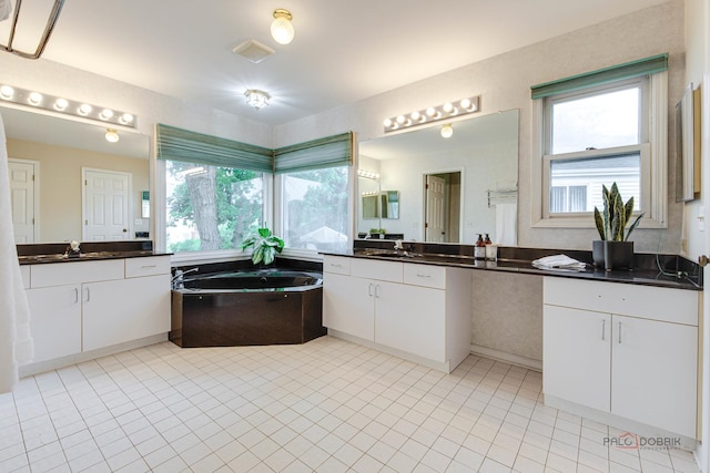 621 Raintree Rd, Buffalo Grove, IL 60089 - bathroom featuring two vanities, a bath, and tile patterned flooring