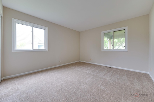 621 Raintree Rd, Buffalo Grove, IL 60089 - spare room featuring light carpet and baseboards