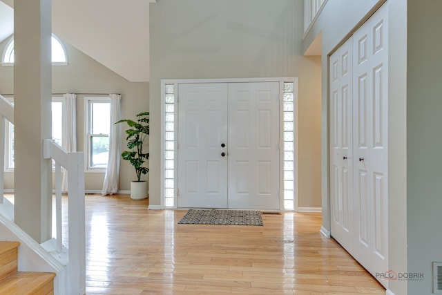 621 Raintree Rd, Buffalo Grove, IL 60089 - entrance foyer with high vaulted ceiling, stairs, and light wood-type flooring