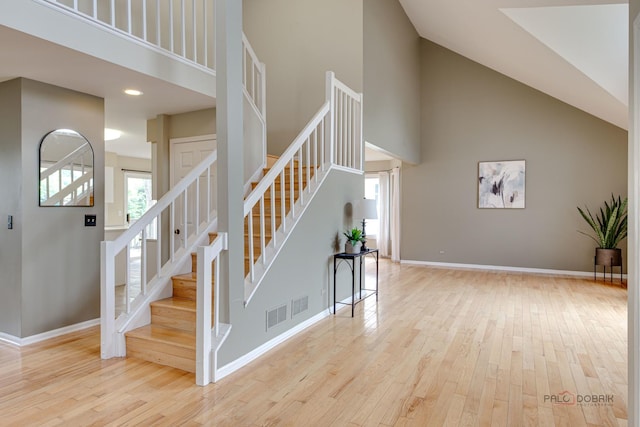 621 Raintree Rd, Buffalo Grove, IL 60089 - stairs featuring high vaulted ceiling and wood finished floors