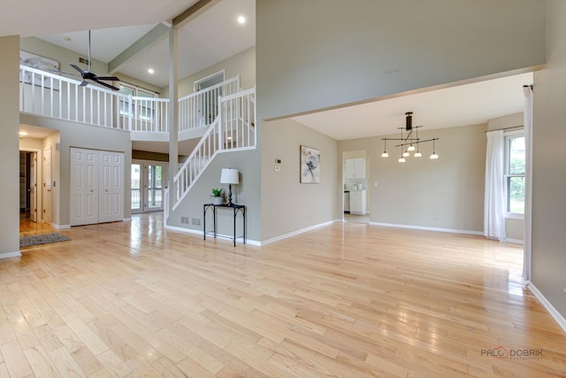 621 Raintree Rd, Buffalo Grove, IL 60089 - unfurnished living room featuring ceiling fan, a towering ceiling, light wood-style flooring, stairway, and recessed lighting