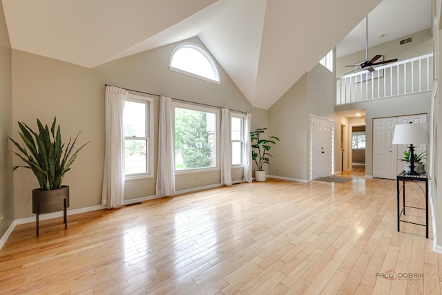 621 Raintree Rd, Buffalo Grove, IL 60089 - unfurnished living room with high vaulted ceiling, a ceiling fan, and light wood finished floors