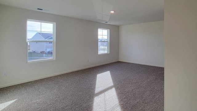 spare room with baseboards and visible vents