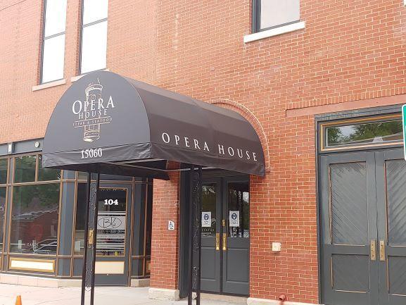 view of exterior entry with french doors and brick siding