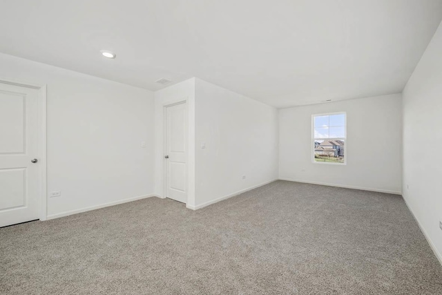 carpeted spare room with recessed lighting and baseboards