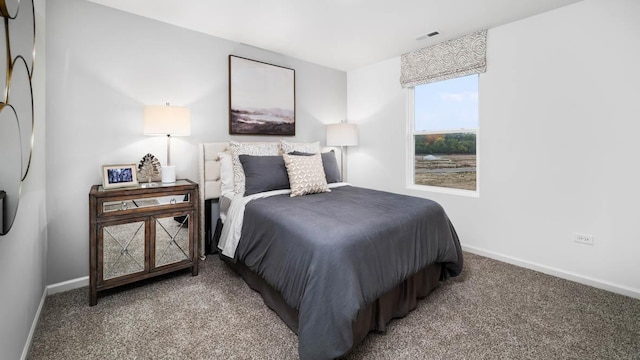 carpeted bedroom featuring baseboards and visible vents