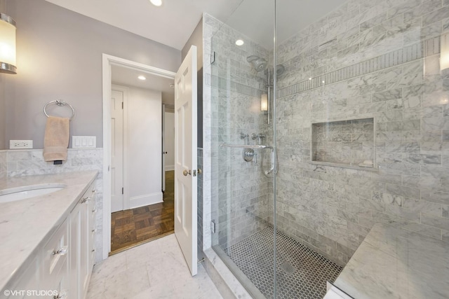 full bathroom featuring a shower stall and vanity