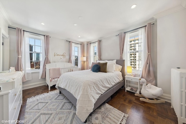 bedroom with radiator heating unit, multiple windows, baseboards, and crown molding