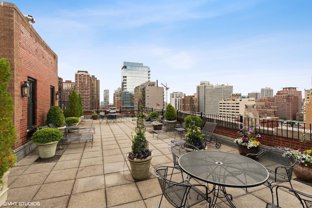 view of patio / terrace featuring outdoor dining area and a city view