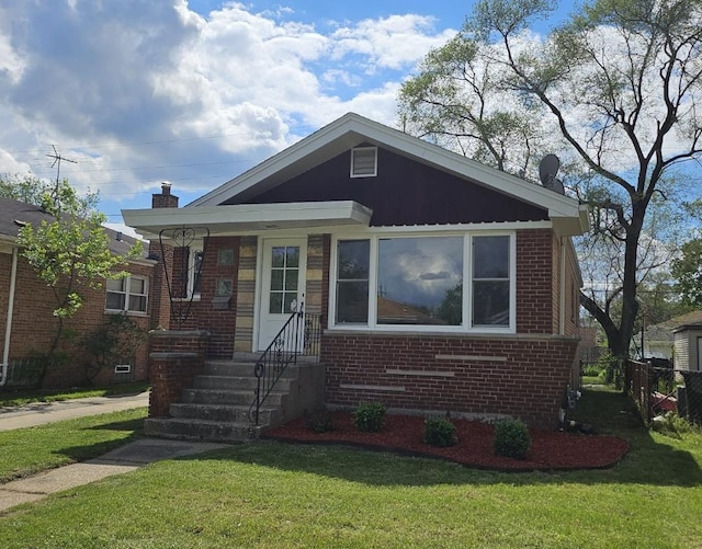 bungalow-style house with a chimney, a front yard, fence, and brick siding