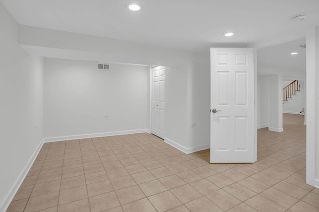 finished basement featuring recessed lighting, visible vents, stairway, and baseboards