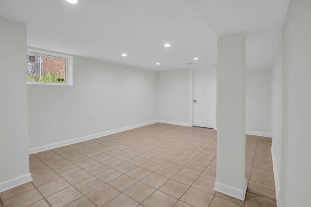 basement featuring baseboards, light tile patterned floors, and recessed lighting