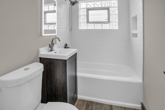 bathroom with vanity, bathtub / shower combination, wood finished floors, and toilet