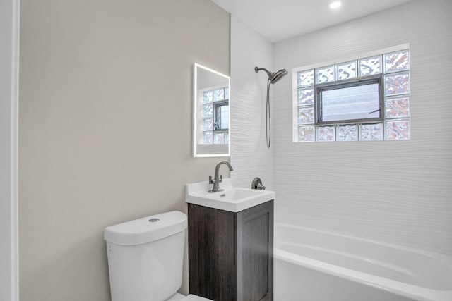 bathroom with bathing tub / shower combination, toilet, and vanity