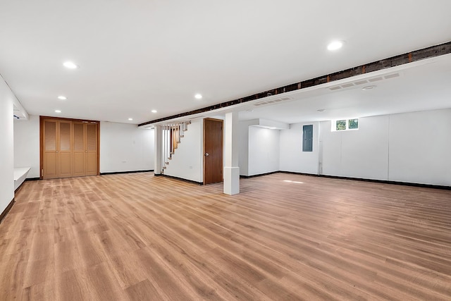 basement featuring recessed lighting, visible vents, light wood-type flooring, baseboards, and stairs