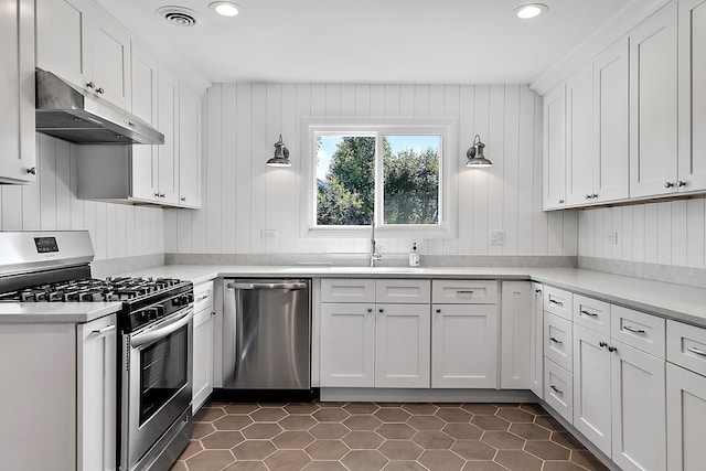 kitchen featuring under cabinet range hood, stainless steel appliances, visible vents, white cabinets, and light countertops