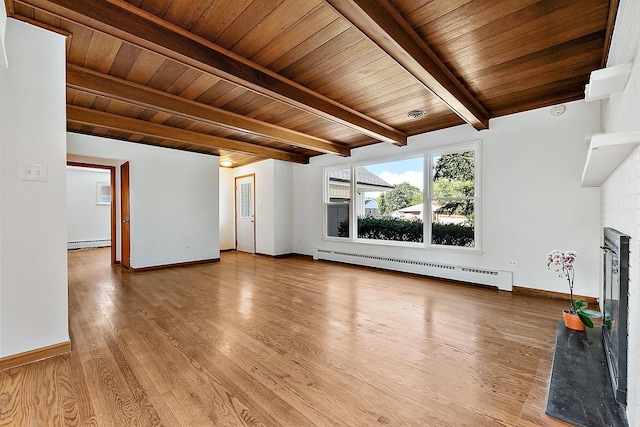 unfurnished living room with wood ceiling, a brick fireplace, a baseboard radiator, and wood finished floors