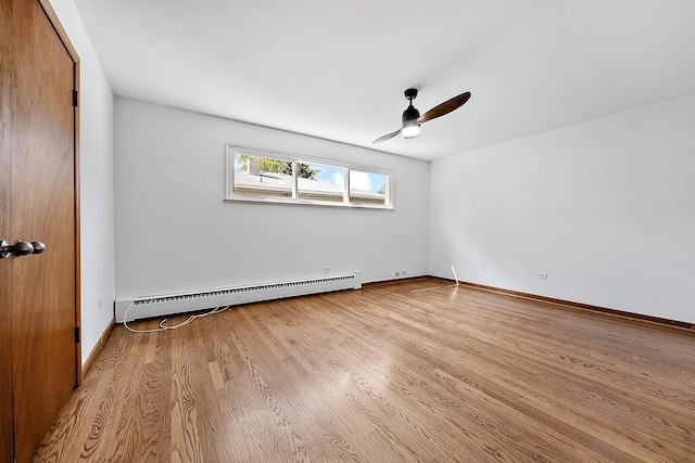 unfurnished room featuring ceiling fan, a baseboard radiator, wood finished floors, and baseboards