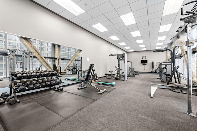 workout area with plenty of natural light and a paneled ceiling