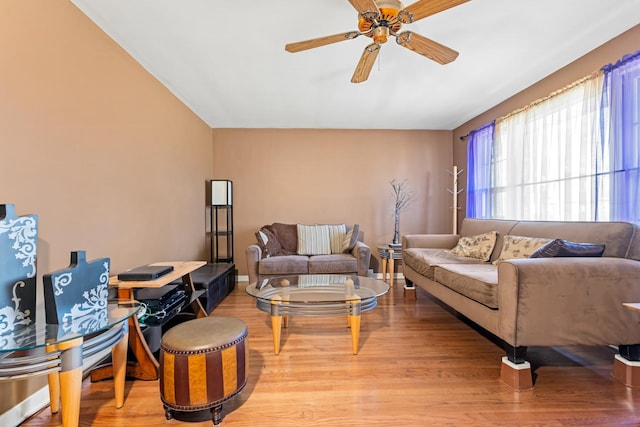 living area with a ceiling fan and light wood finished floors