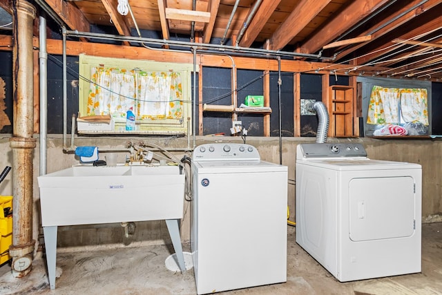 laundry area with a sink, independent washer and dryer, and laundry area