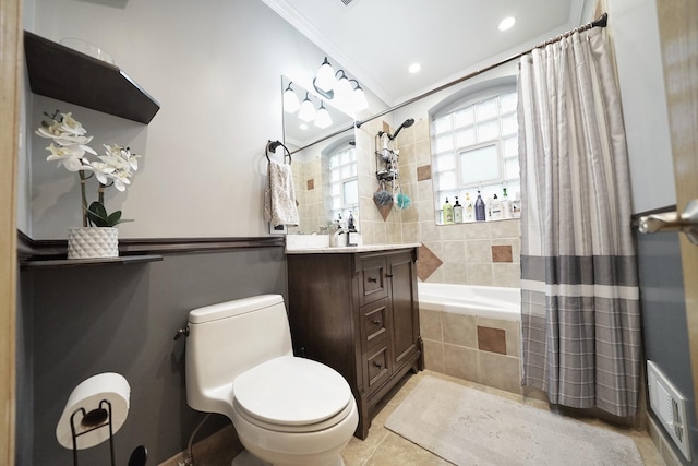 full bathroom featuring visible vents, toilet, ornamental molding, tiled shower / bath, and vanity