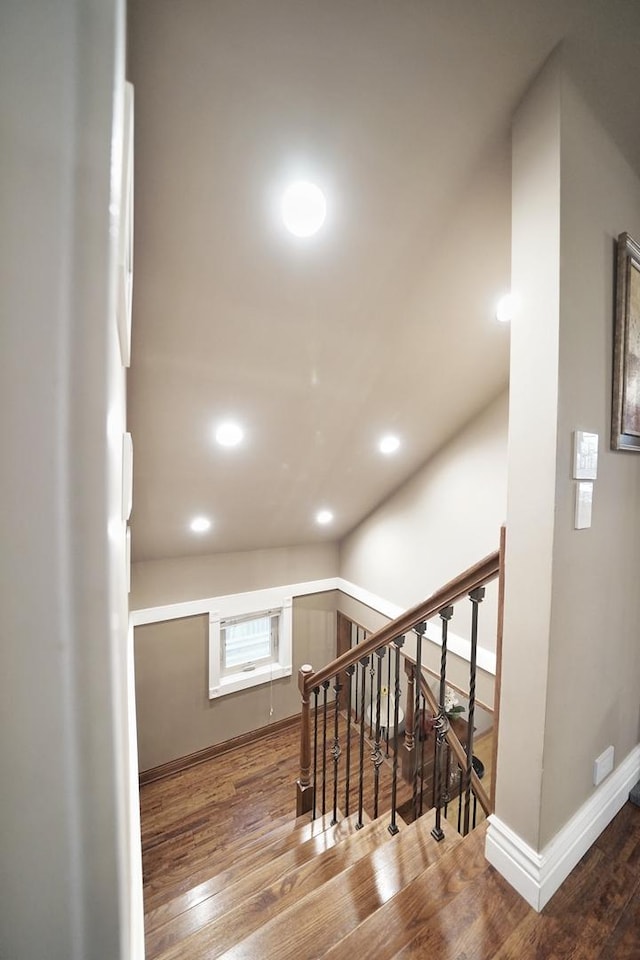 stairs with recessed lighting, wood finished floors, and baseboards