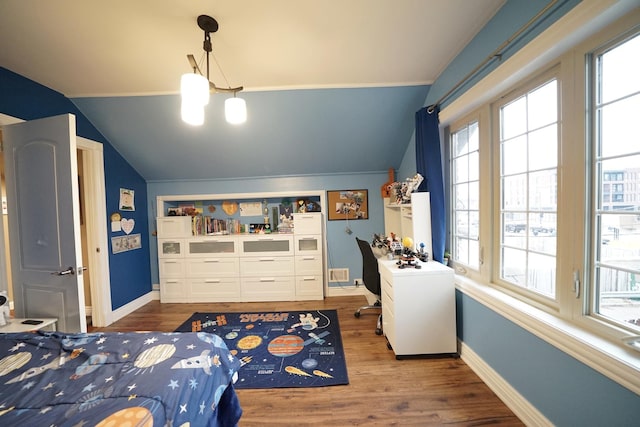 bedroom featuring lofted ceiling, baseboards, and wood finished floors