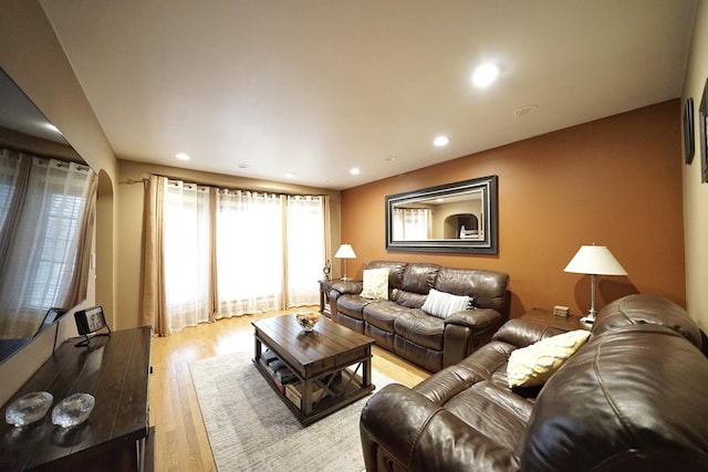 living area with light wood finished floors and recessed lighting