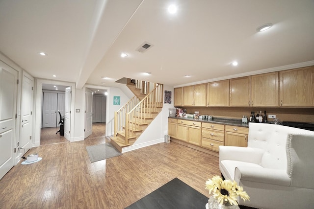 kitchen with recessed lighting, visible vents, baseboards, light brown cabinetry, and light wood finished floors