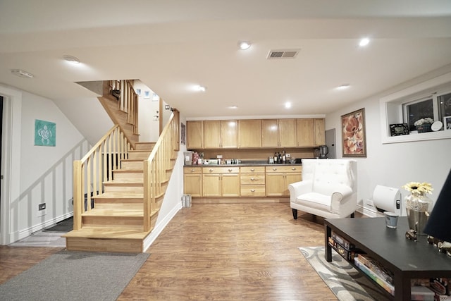 interior space with stairs, light wood-type flooring, visible vents, and recessed lighting