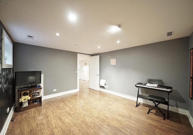 interior space featuring wood finished floors, visible vents, and baseboards