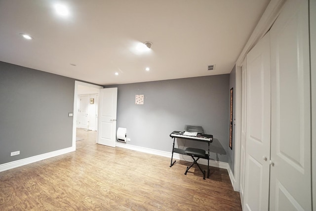 interior space featuring light wood-type flooring, visible vents, baseboards, and recessed lighting