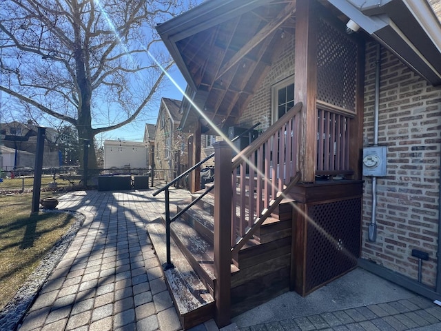 view of side of property featuring a patio area and brick siding