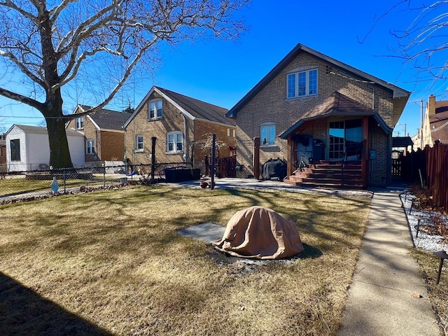 view of front of house with brick siding and fence