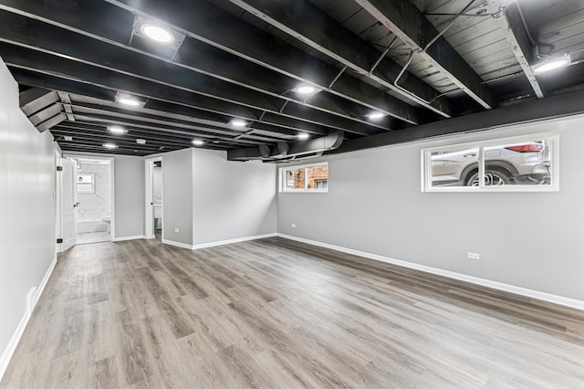 basement with wood finished floors and baseboards