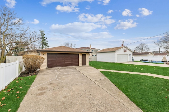 view of front facade featuring an outbuilding, a garage, and a front lawn