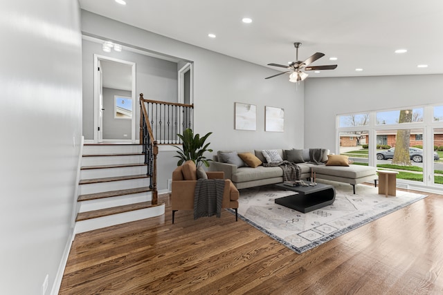living area featuring stairway, ceiling fan, recessed lighting, and wood finished floors
