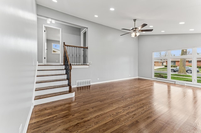 unfurnished living room with a ceiling fan, visible vents, recessed lighting, wood finished floors, and baseboards