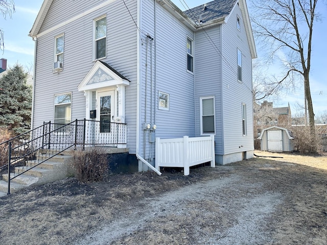 view of front of property featuring a storage shed and an outdoor structure